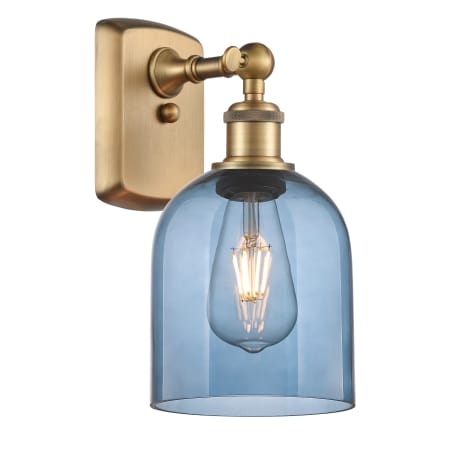 A large image of the Innovations Lighting 516-1W-11-6 Bella Sconce Brushed Brass / Princess Blue