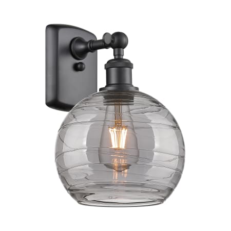 A large image of the Innovations Lighting 516-1W-11-8 Athens Deco Swirl Sconce Matte Black / Light Smoke Deco Swirl