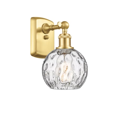 A large image of the Innovations Lighting 516-1W-11-6 Athens Sconce Satin Gold / Clear Water Glass