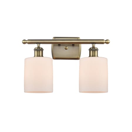 A large image of the Innovations Lighting 516-2W-9-16 Cobbleskill Vanity Matte White / Antique Brass