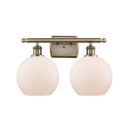 A large image of the Innovations Lighting 516-2W-12-18 Athens Vanity Antique Brass / Matte White