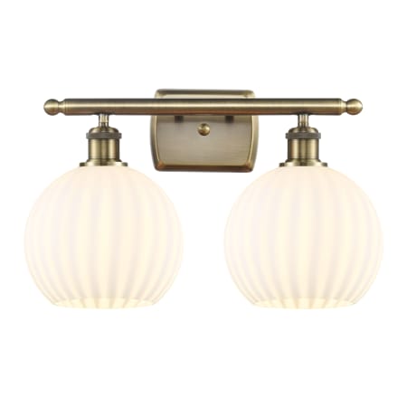 A large image of the Innovations Lighting 516-2W-11-18 White Venetian Vanity Antique Brass / White Venetian