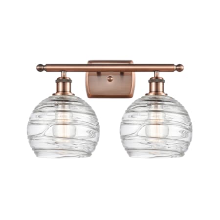 A large image of the Innovations Lighting 516-2W Deco Swirl Antique Copper / Clear