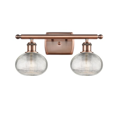 A large image of the Innovations Lighting 516-2W-8-16 Ithaca Vanity Antique Copper / Clear Ithaca