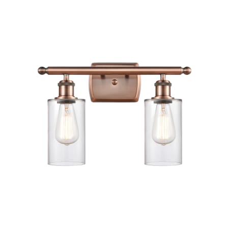 A large image of the Innovations Lighting 516-2W-12-16 Clymer Vanity Clear / Antique Copper