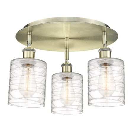 A large image of the Innovations Lighting 516-3C-10-18 Cobbleskill Flush Antique Brass / Deco Swirl