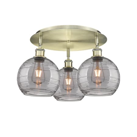 A large image of the Innovations Lighting 516-3C 11 20 Athens Deco Swirl Semi-Flush Antique Brass / Light Smoke Deco Swirl