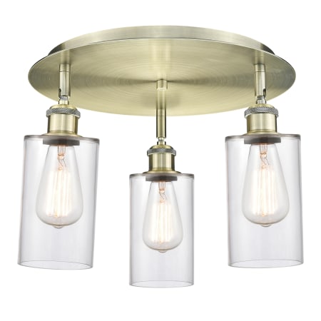 A large image of the Innovations Lighting 516-3C-10-16 Clymer Flush Antique Brass / Clear