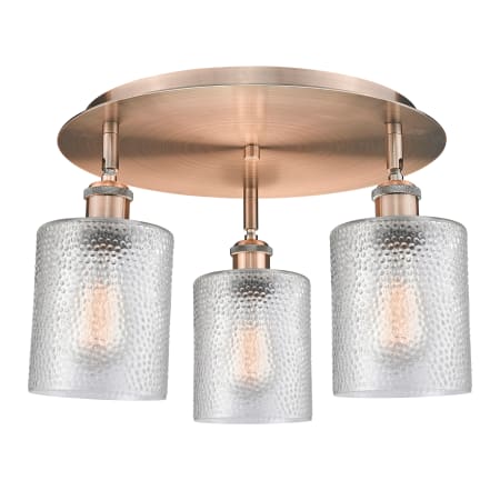 A large image of the Innovations Lighting 516-3C-10-18 Cobbleskill Flush Antique Copper / Clear
