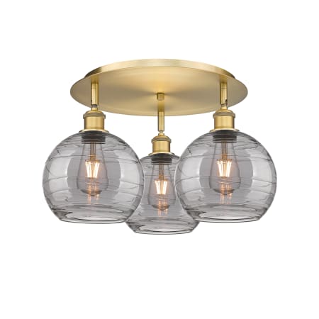 A large image of the Innovations Lighting 516-3C 11 20 Athens Deco Swirl Semi-Flush Brushed Brass / Light Smoke Deco Swirl