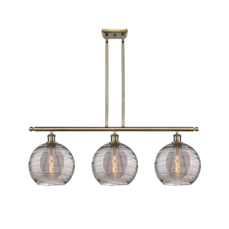 A large image of the Innovations Lighting 516-3I 12 37 Athens Deco Swirl Chandelier Antique Brass / Light Smoke Deco Swirl