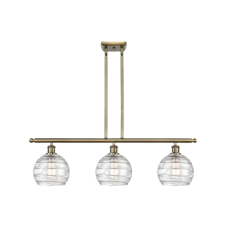 A large image of the Innovations Lighting 516-3I-11-36 Athens Linear Antique Brass / Clear Deco Swirl