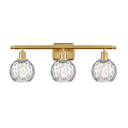 A large image of the Innovations Lighting 516-3W-11-26 Athens Vanity Satin Gold / Clear Water Glass