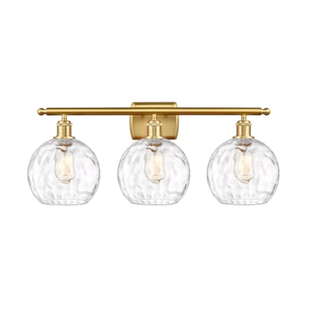 A large image of the Innovations Lighting 516-3W-13-26 Athens Vanity Satin Gold / Clear Water Glass