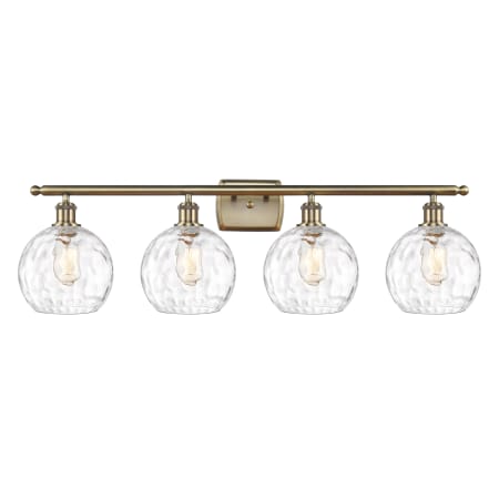 A large image of the Innovations Lighting 516-4W-11-36 Athens Vanity Antique Brass / Clear Water Glass