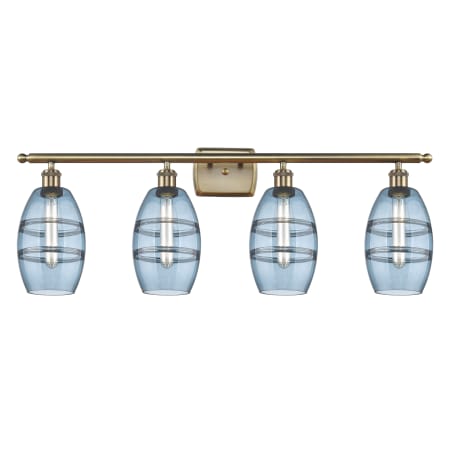 A large image of the Innovations Lighting 516-4W-9-36 Vaz Vanity Antique Brass / Blue