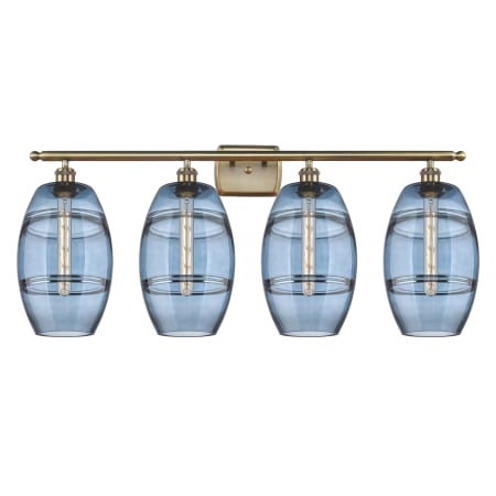 A large image of the Innovations Lighting 516-4W-11-38 Vaz Vanity Antique Brass / Blue