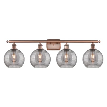 A large image of the Innovations Lighting 516-4W 11 38 Athens Deco Swirl Vanity Antique Copper / Light Smoke Deco Swirl