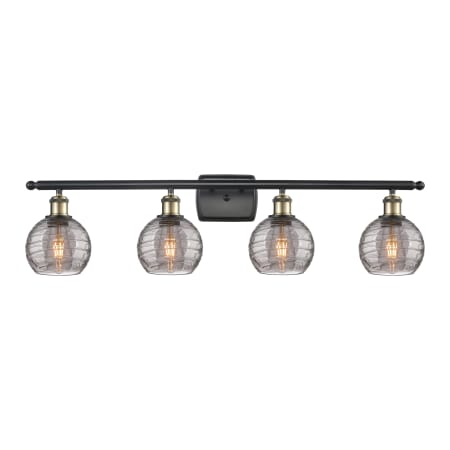 A large image of the Innovations Lighting 516-4W 9 36 Athens Deco Swirl Vanity Black Antique Brass / Light Smoke Deco Swirl