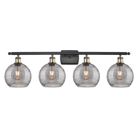 A large image of the Innovations Lighting 516-4W 11 38 Athens Deco Swirl Vanity Black Antique Brass / Light Smoke Deco Swirl