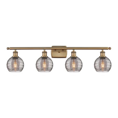 A large image of the Innovations Lighting 516-4W 9 36 Athens Deco Swirl Vanity Brushed Brass / Light Smoke Deco Swirl