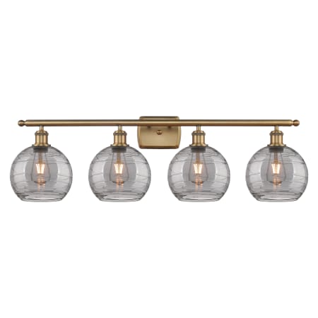 A large image of the Innovations Lighting 516-4W 11 38 Athens Deco Swirl Vanity Brushed Brass / Light Smoke Deco Swirl