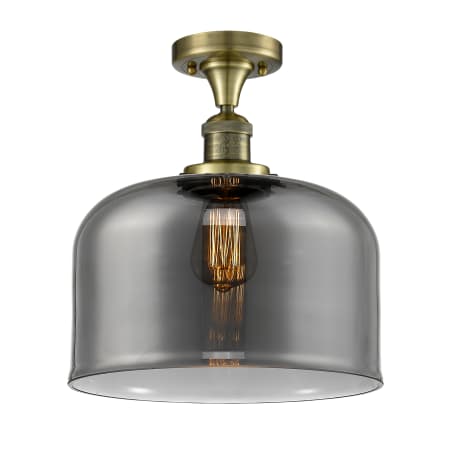 A large image of the Innovations Lighting 517 X-Large Bell Antique Brass / Plated Smoke