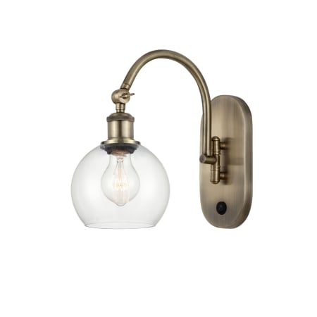 A large image of the Innovations Lighting 518-1W-12-6 Athens Sconce Antique Brass / Clear