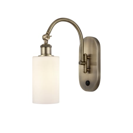 A large image of the Innovations Lighting 518-1W-13-6 Clymer Sconce Antique Brass / Matte White