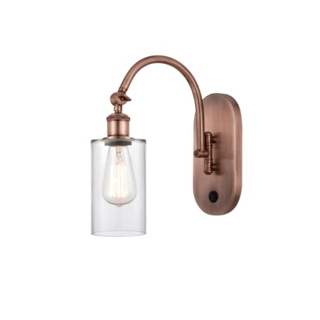 A large image of the Innovations Lighting 518-1W-13-5 Clymer Sconce Antique Copper / Clear