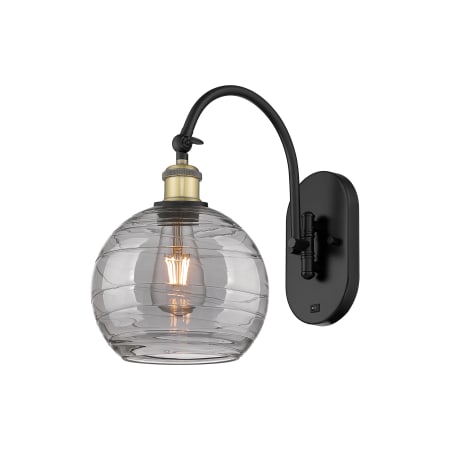 A large image of the Innovations Lighting 518-1W 13 8 Athens Deco Swirl Sconce Black Antique Brass / Light Smoke Deco Swirl