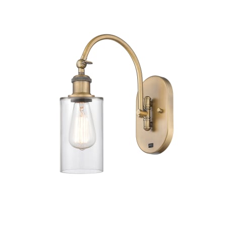 A large image of the Innovations Lighting 518-1W-13-5 Clymer Sconce Brushed Brass / Clear