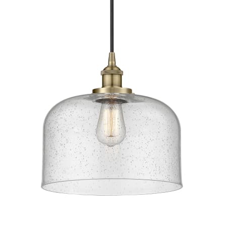 A large image of the Innovations Lighting 616-1PH-12-12-L Bell Pendant Antique Brass / Seedy