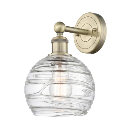 A large image of the Innovations Lighting 616-1W-13-8 Athens Sconce Antique Brass / Clear Deco Swirl