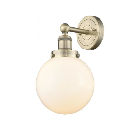 A large image of the Innovations Lighting 616-1W-10-7-L Beacon Sconce Antique Brass / Matte White