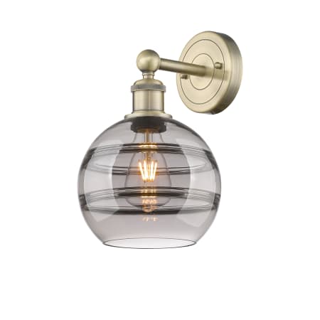 A large image of the Innovations Lighting 616-1W 12 8 Rochester Sconce Antique Brass / Light Smoke