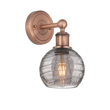 A large image of the Innovations Lighting 616-1W 10 6 Athens Deco Swirl Sconce Antique Copper / Light Smoke Deco Swirl