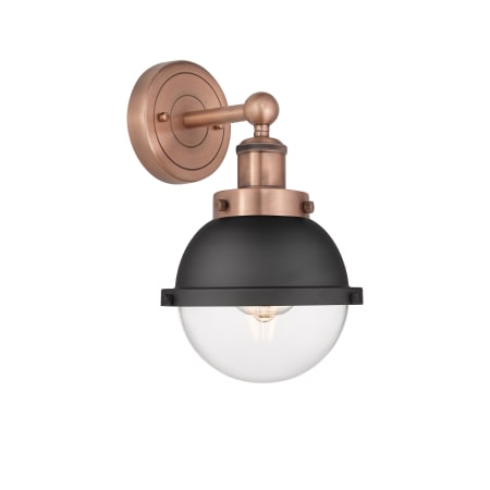 A large image of the Innovations Lighting 616-1W-12-7 Hampden Sconce Antique Copper / Matte Black / Clear