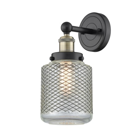 A large image of the Innovations Lighting 616-1W-12-6 Stanton Sconce Black Antique Brass / Clear Wire Mesh