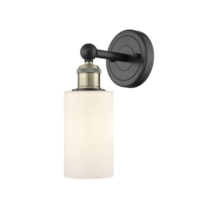 A large image of the Innovations Lighting 616-1W-11-4 Clymer Sconce Black Antique Brass / Matte White