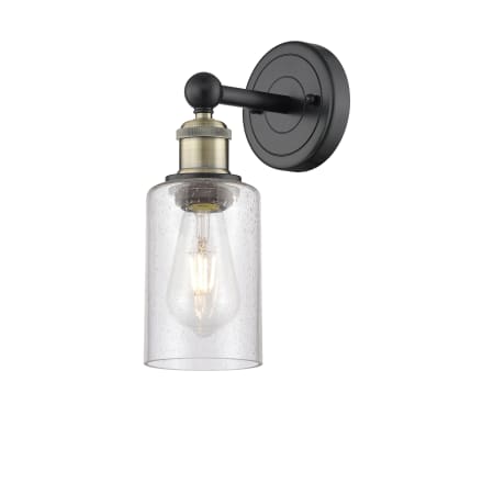 A large image of the Innovations Lighting 616-1W-11-4 Clymer Sconce Black Antique Brass / Seedy