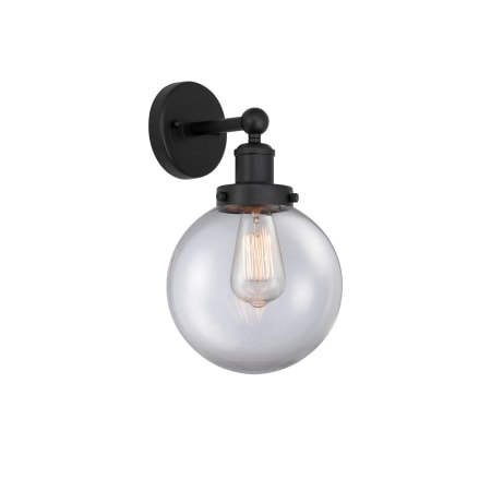 A large image of the Innovations Lighting 616-1W-10-7-L Beacon Sconce Matte Black / Clear