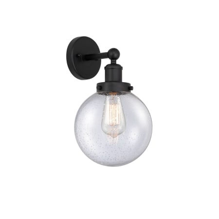 A large image of the Innovations Lighting 616-1W-10-7-L Beacon Sconce Matte Black / Seedy