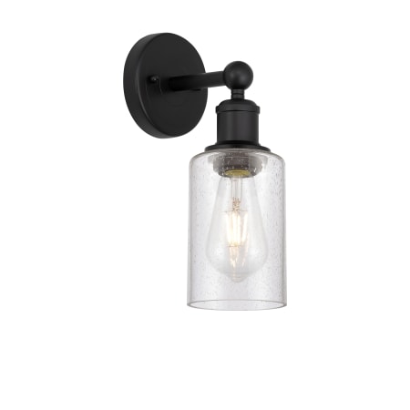 A large image of the Innovations Lighting 616-1W-11-4 Clymer Sconce Matte Black / Seedy