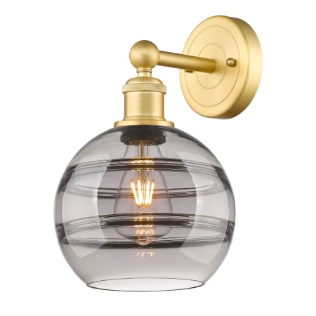 A large image of the Innovations Lighting 616-1W 12 8 Rochester Sconce Satin Gold / Light Smoke