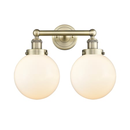 A large image of the Innovations Lighting 616-2W-10-16-L Beacon Vanity Antique Brass / Matte White