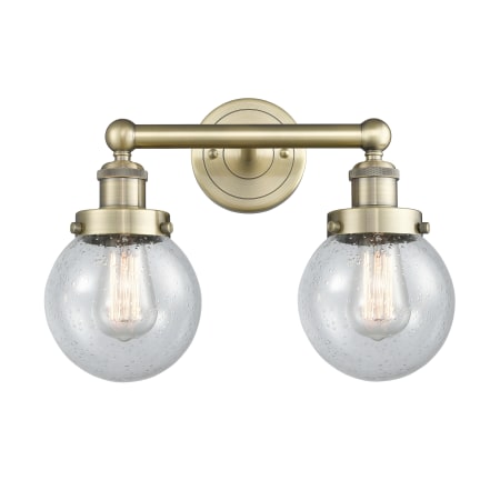 A large image of the Innovations Lighting 616-2W-10-16 Beacon Vanity Antique Brass / Seedy