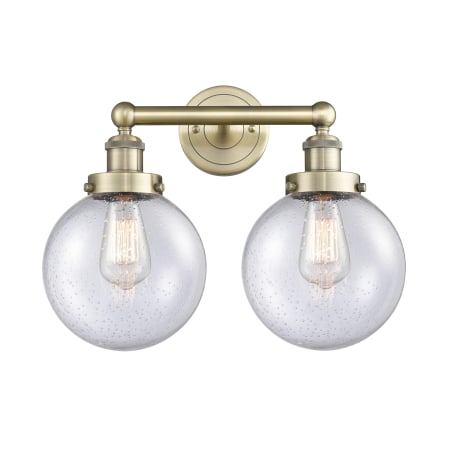 A large image of the Innovations Lighting 616-2W-10-16-L Beacon Vanity Antique Brass / Seedy