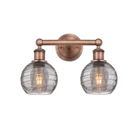 A large image of the Innovations Lighting 616-2W 10 15 Athens Deco Swirl Vanity Antique Copper / Light Smoke Deco Swirl