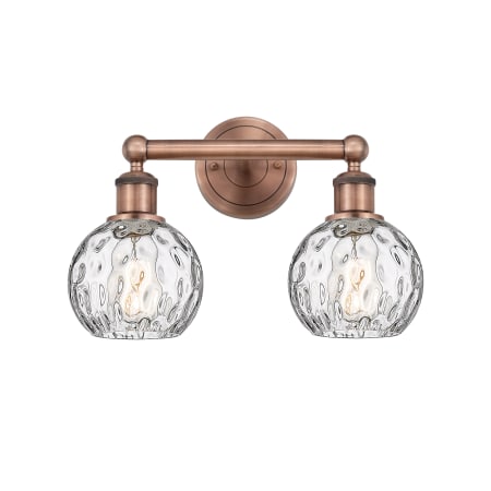 A large image of the Innovations Lighting 616-2W-11-15 Athens Vanity Antique Copper / Clear Water Glass